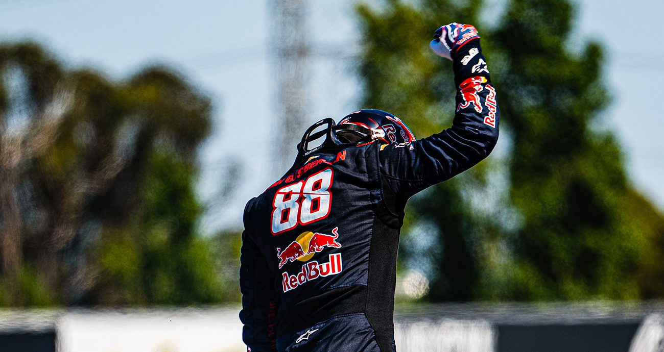 Shane van Gisbergen celebrates on top of car after race win at Sonoma.