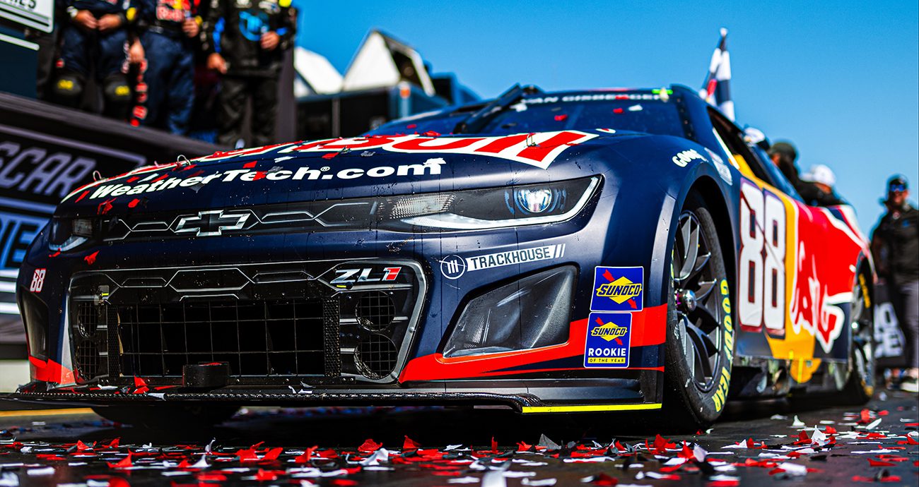 The No. 88 Red Bull car sits in Victory Lane with confetti on it.