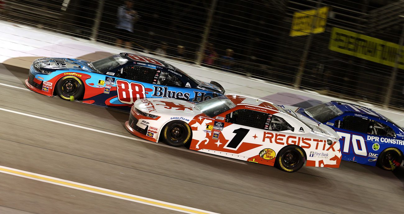 Carson Kvapil, in the No. 1 JR Motorsports Chevrolet, races next to Connor Zilisch's No. 88 JR Motorsports Chevy during a NASCAR Xfinity Series race at EchoPark Speedway (formerly Atlanta Motor Speedway).