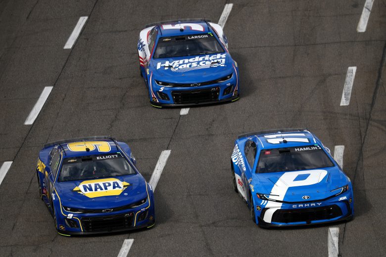 Chase Elliott, Denny Hamlin and Kyle Larson race in a NASCAR Cup Series event.