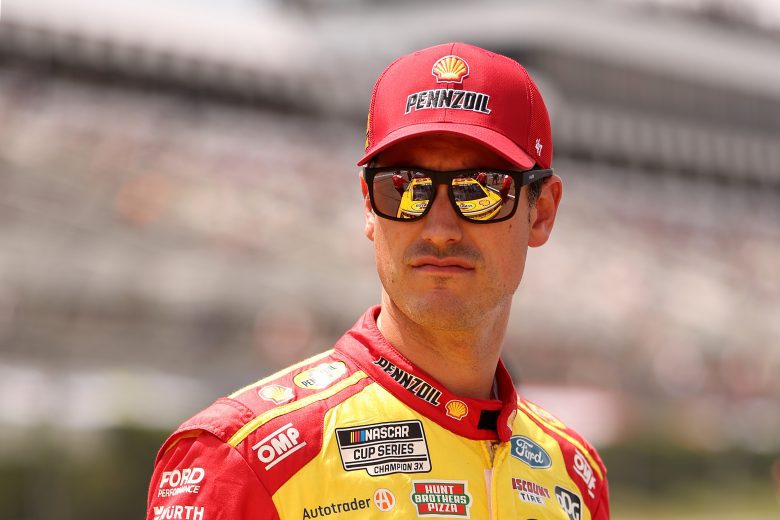 Joey Logano looks on.
