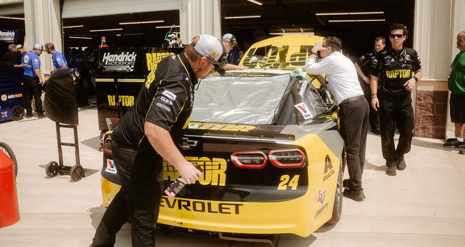 Hendrick Motorsports crew members work on the No. 24 Chevrolet ahead of the 21st Cup Series race of the 2025 season at Dover Motor Speedway.