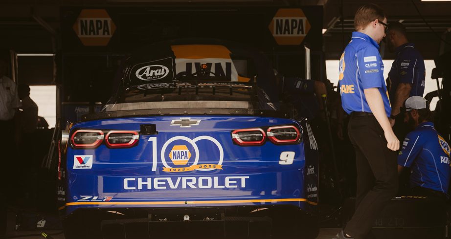 Hendrick Motorsports crew members work on the No. 9 Chevrolet in the garage.