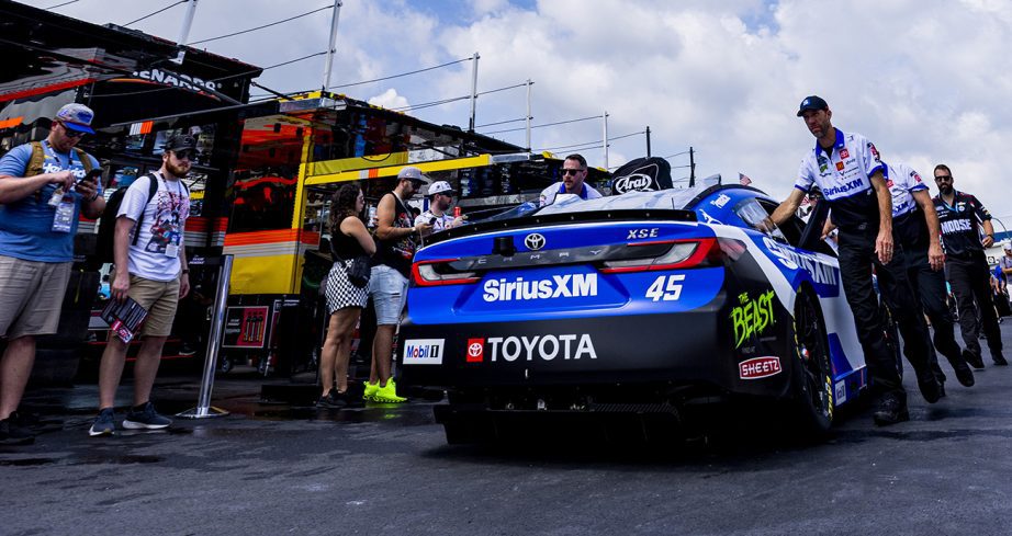 23XI Racing crew members push the No. 45 Toyota out to pit road before the start of the Cup Series race at Dover Motor Speedway.