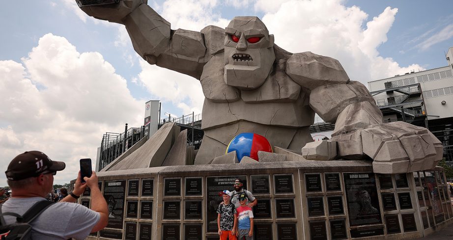 Fans take a photo in front of Miles the Monster before the Cup Series race at Dover Motor Speedway.