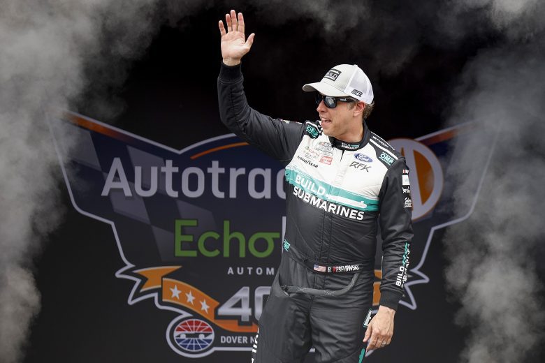 Brad Keselowski, driver of the No. 6 BuildSubmarines.com Ford, waves to fans as he walks onstage during driver intros.