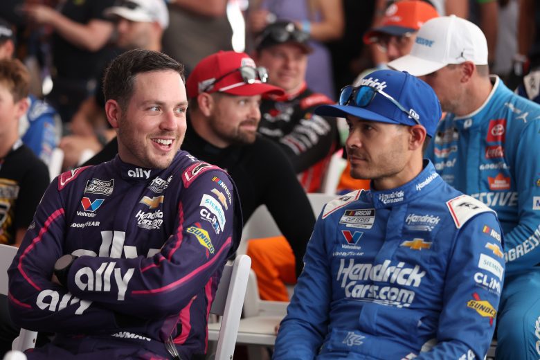 Hendrick Motorsport teammates Alex Bowman (left) and Kyle Larson (right) talk during the driver drivers meeting