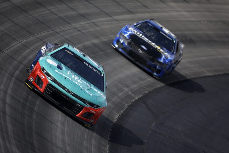 Michael McDowell races ahead of Noah Gragson at Dover.