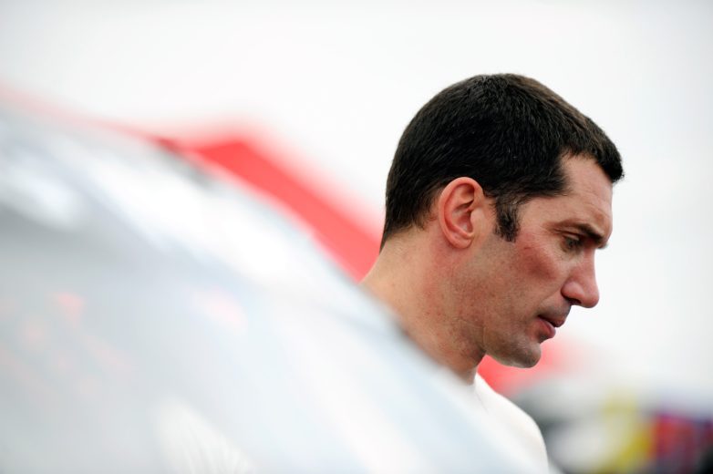 Max Papis looks on.
