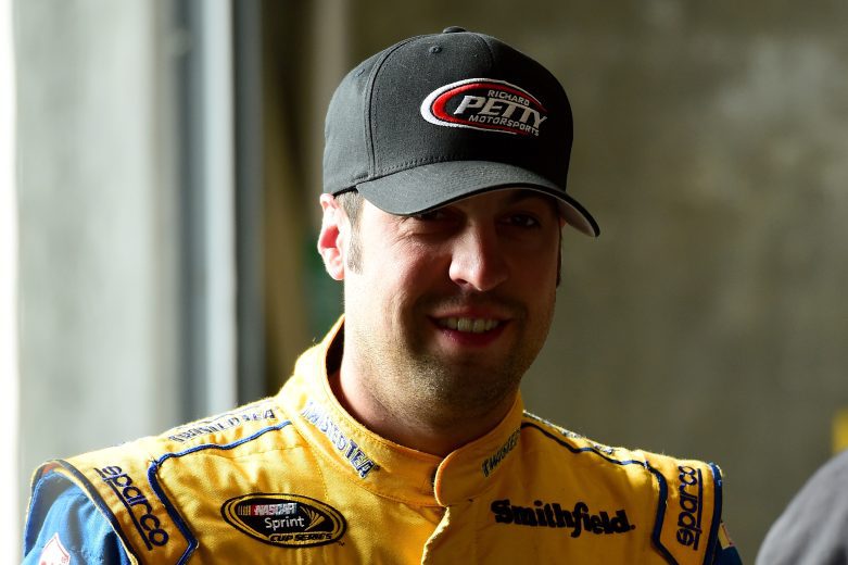 Sam Hornish Jr. looks on.