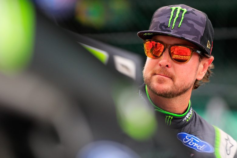 Kurt Busch looks on.