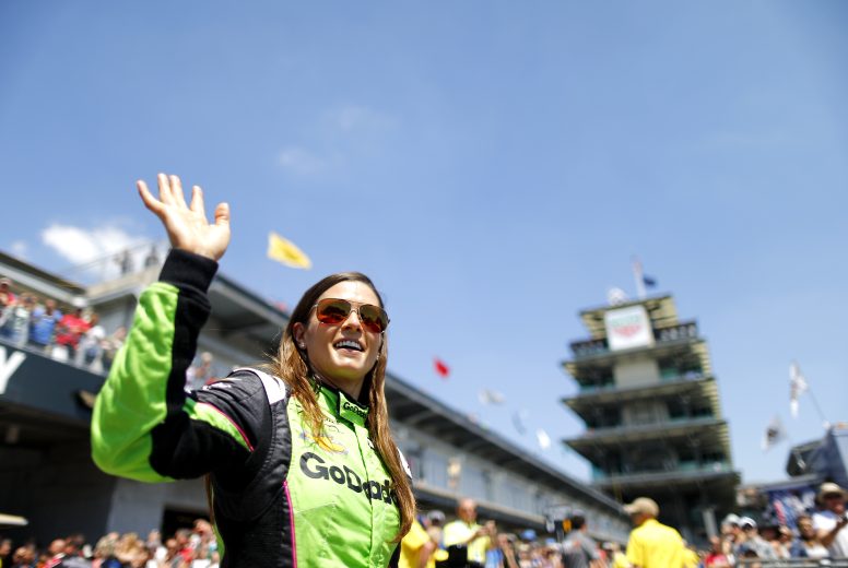 Danica Patrick waves to fans as she walks the grid at Indy.