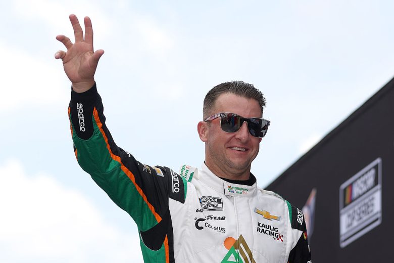 AJ Allmendinger looks on.