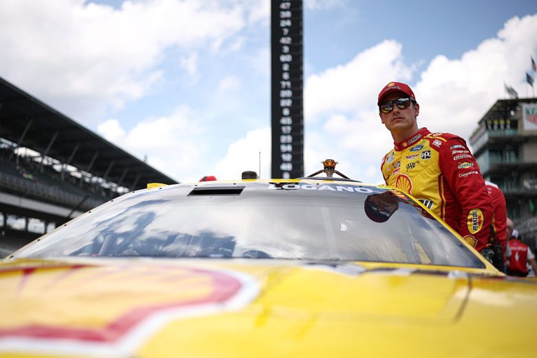 Joey Logano enters his car at Indianapolis.