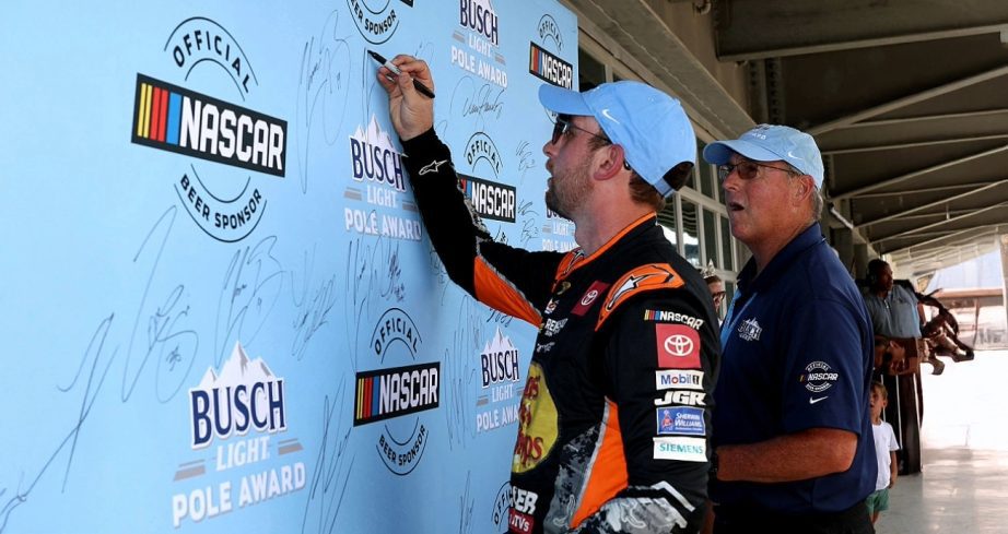 Chase Briscoe signs the pole board at Indianapolis.