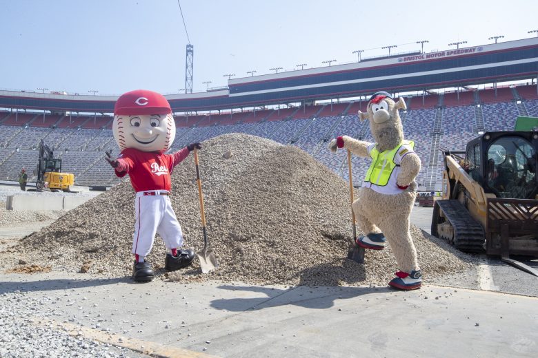 Cincinnati Reds mascot Mr. Red (L) and Atlanta Braves mascot Blooper (R) pose for a photo at Bristol Motor Speedway.