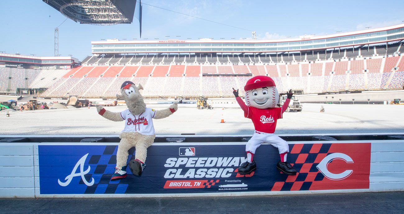 Atlanta Braves mascot Blooper (L) and Cincinnati Reds mascot Mr. Red (R) pose for a photo at Bristol Motor Speedway.