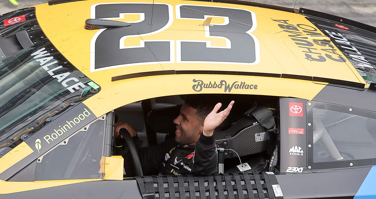 Bubba Wallace waves after winning the Brickyard 400 at Indianapolis Motor Speedway