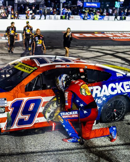 Chase Briscoe leans against his No. 19 Joe Gibbs Racing Toyota.