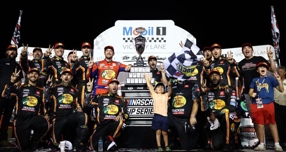Chase Briscoe and his No. 19 Joe Gibbs Racing pit crew pose for a photo in Victory Lane at Darlington Raceway.
