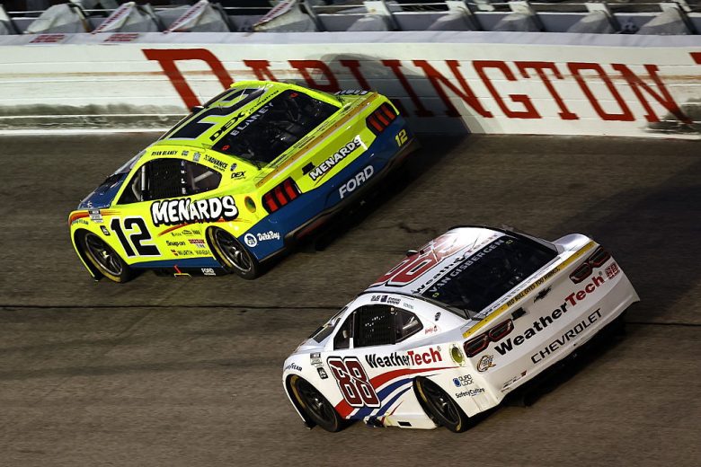 Ryan Blaney, in the No. 12 Team Penske Ford, races ahead of Shane van Gisbergen in the No. 88 Trackhouse Racing Chevrolet at Darlington Raceway.