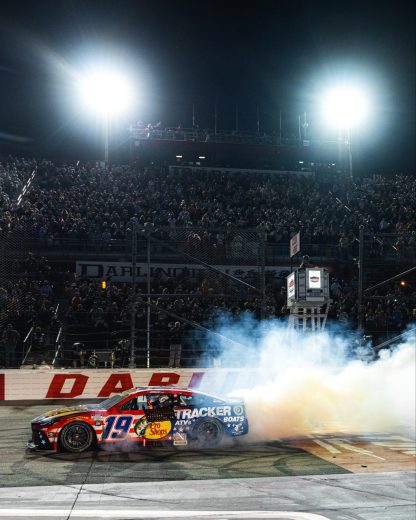 Chase Briscoe does a celebratory burnout in his No. 19 Joe Gibbs Racing Toyota at Darlington Raceway.