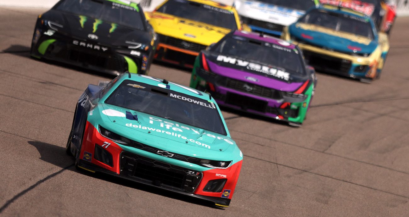 Michael McDowell races ahead of Riley Herbst and Zane Smith at Iowa Speedway.