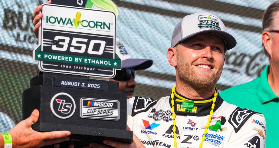 William Byron smiles and holds up Iowa Corn 350 trophy in Victory Lane.