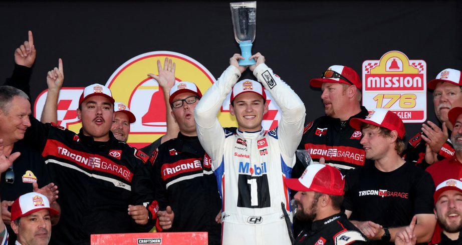 Corey Heim hoists the winner trophy in Victory Lane following his NASCAR Craftsman Truck Series win at Watkins Glen International.
