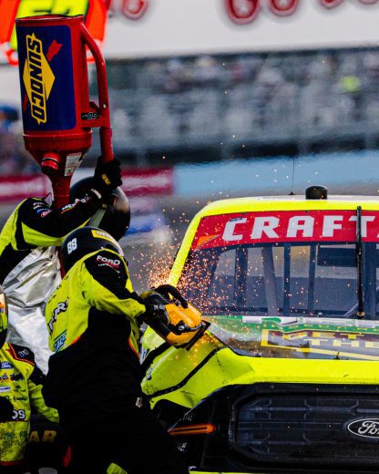 The pit crew for Matt Crafton's No. 88 ThorSport Racing Ford work on the racing machine during a NASCAR Craftsman Truck Series race at Watkins Glen International.