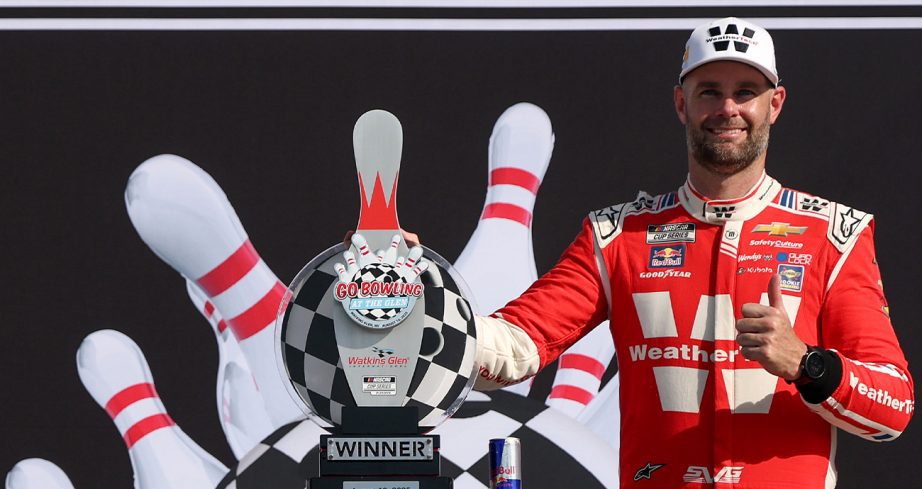 Shane van Gisbergen stands in Victory Lane at Watkins Glen.