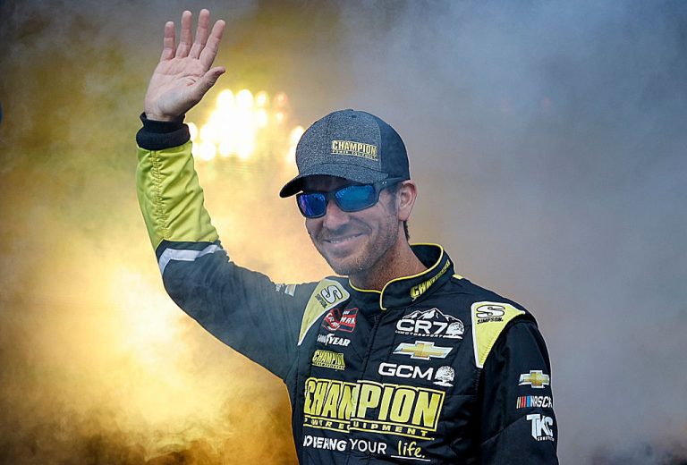 Grant Enfinger waves to the crowd before a NASCAR Craftsman Truck Series race.