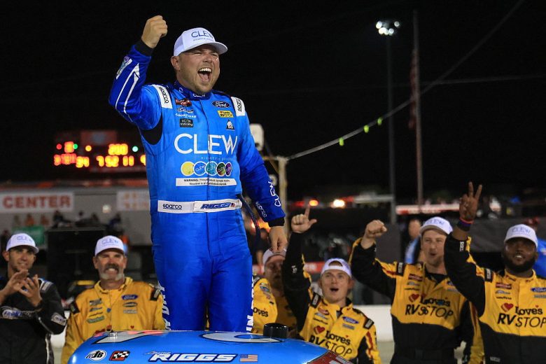 Layne Riggs stands atop his No. 34 Front Row Motorsports Ford following his NASCAR Craftsman Truck Series win at Lucas Oil Indianapolis Raceway Park.