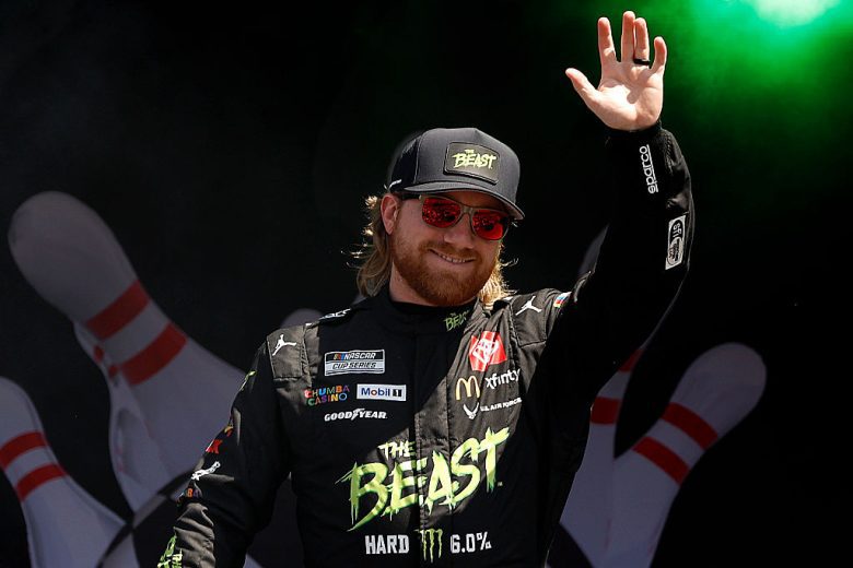 Tyler Reddick waves to fans.
