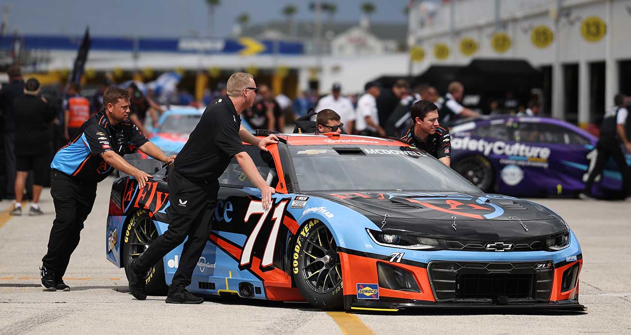 Spire Motorsports crew push the No. 71 Chevy of Michael McDowell in the Daytona International Speedway garage