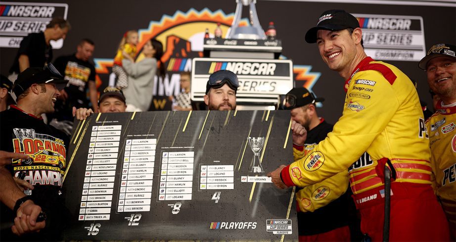 Joey Logano smiles in Victory Lane after winning the title.