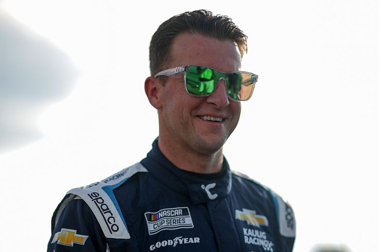 AJ Allmendinger looks on.