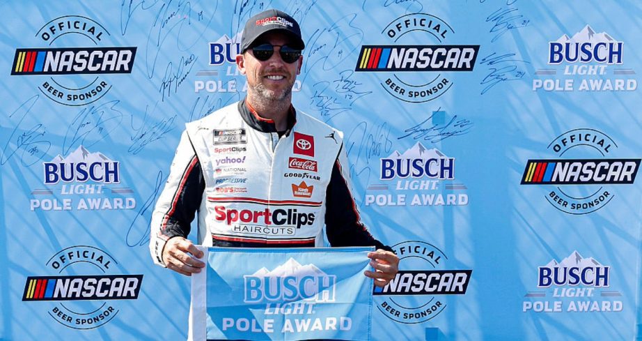 Denny Hamlin celebrates after winning the pole at Darlington.