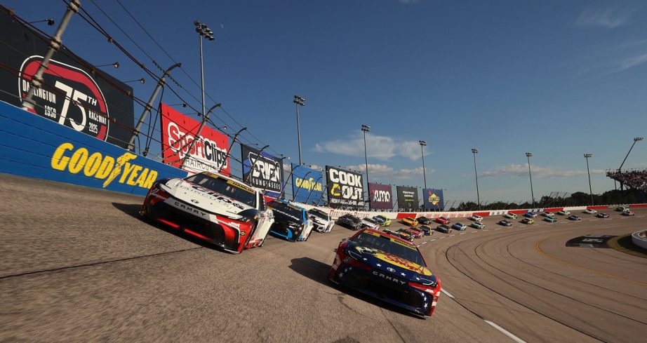 NASCAR Cup Series cars round a turn at Darlington Raceway.