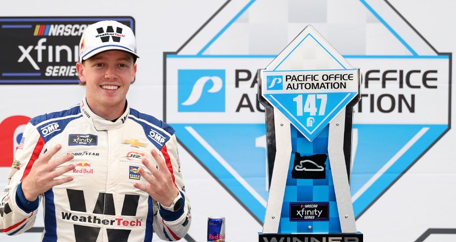 Connor Zilisch poses for a photo in Victory Lane following his NASCAR Xfinity Series win at Portland International Raceway.