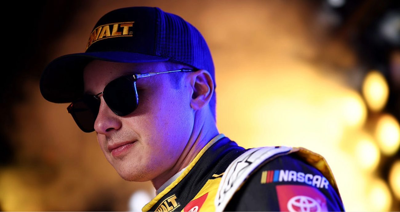 Christopher Bell looks on.