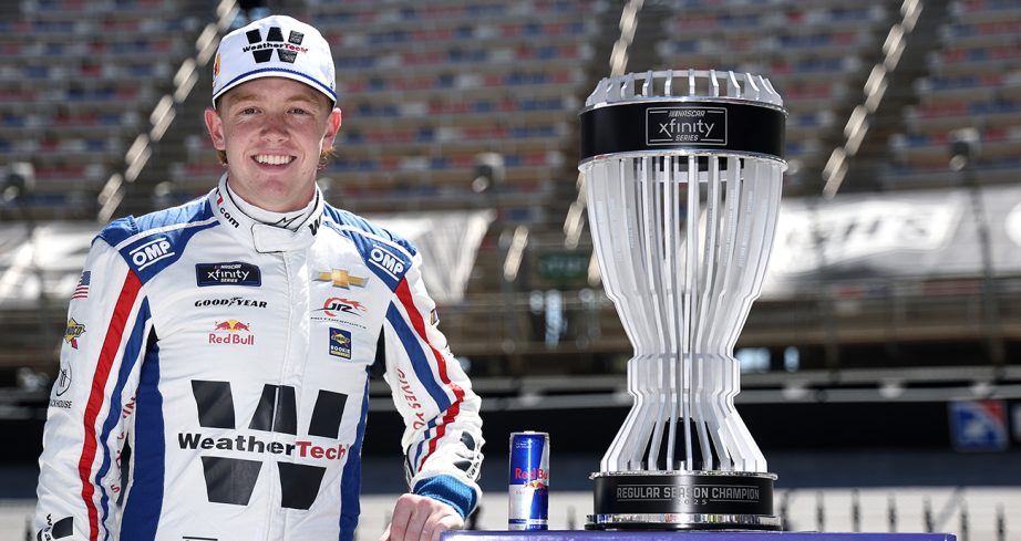 connor zilisch stands with his xfinity series regular season championship trophy