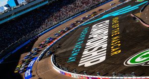 Cars race around Phoenix Raceway.