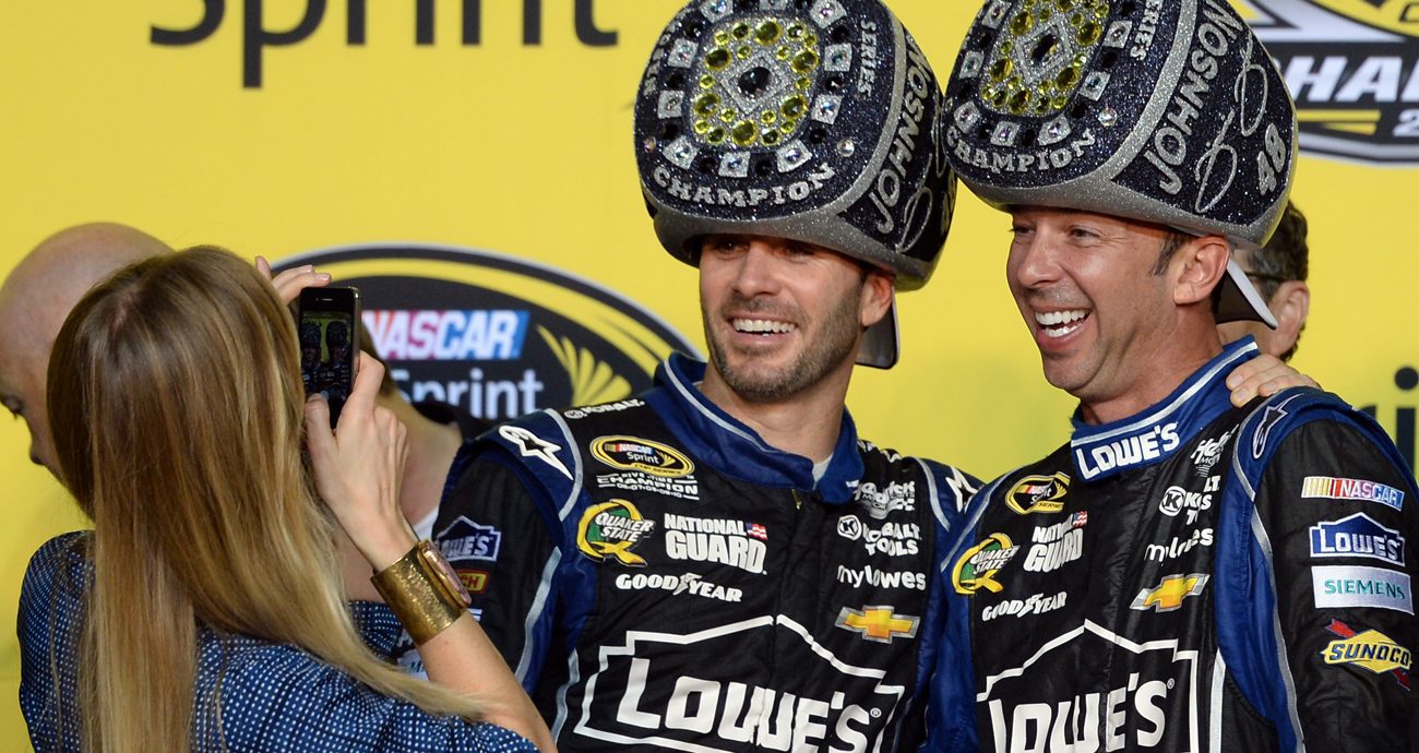 Jimmie Johnson, driver of the No. 48 Lowe's/Kobalt Tools Chevrolet, celebrates with his wife Chandra and crew chief Chad Knaus in Victory Lane following the NASCAR Cup Series Ford EcoBoost 400 at Homestead-Miami Speedway on Nov. 17, 2013 in Homestead, Florida.