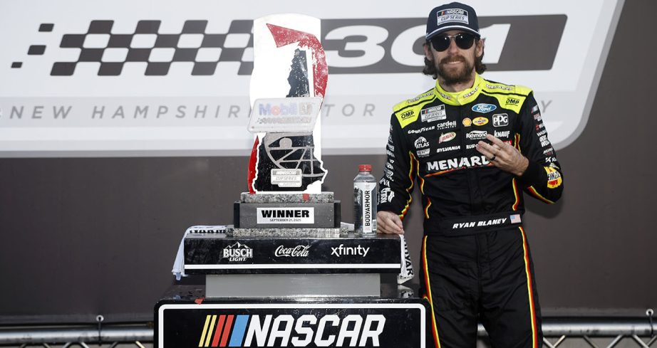 blaney poses with winners trophy