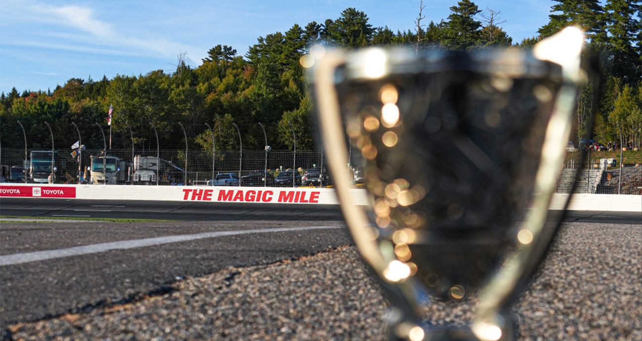 cup championship tropgy in foreground with track in back