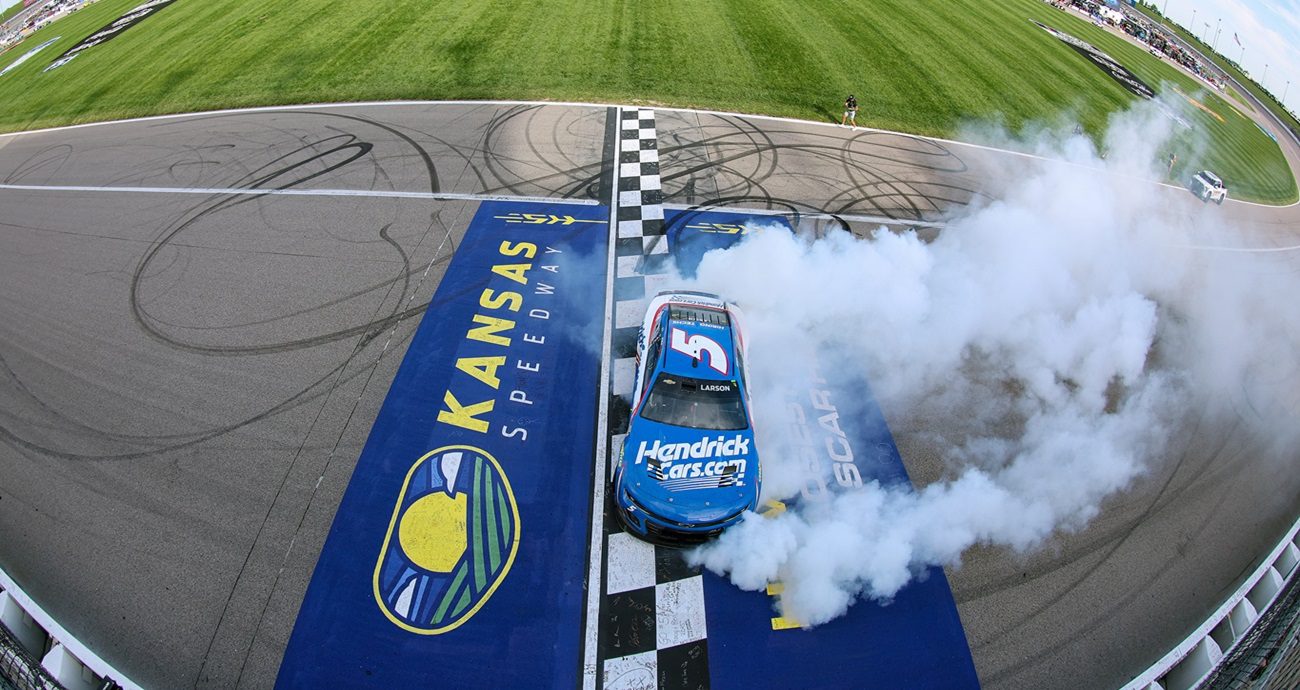 KANSAS CITY, KANSAS - MAY 11: Kyle Larson, driver of the #5 HendrickCars.com Chevrolet, celebrates with a burnout after winning the NASCAR Cup Series AdventHealth 400 at Kansas Speedway on May 11, 2025 in Kansas City, Kansas. (Photo by