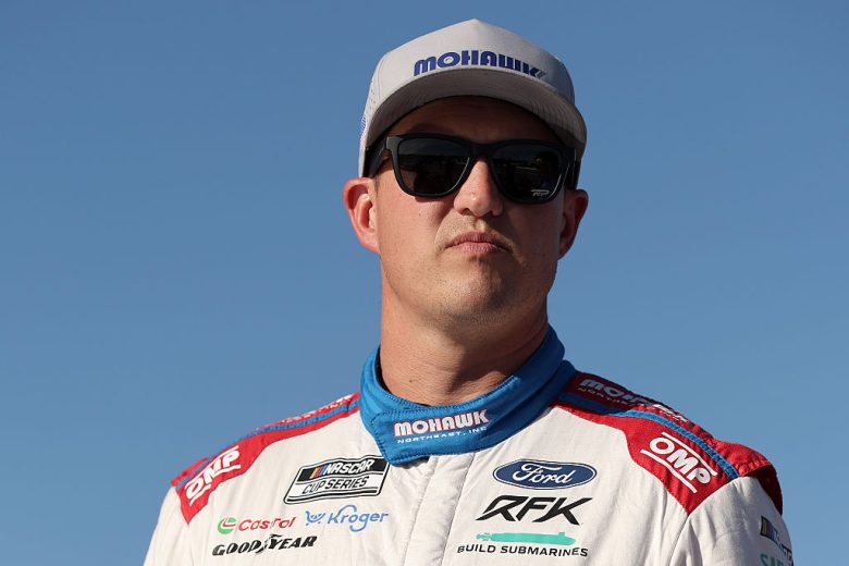 Ryan Preece looks on.