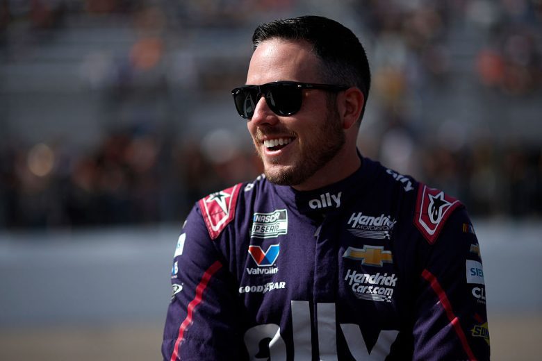 Alex Bowman looks on.