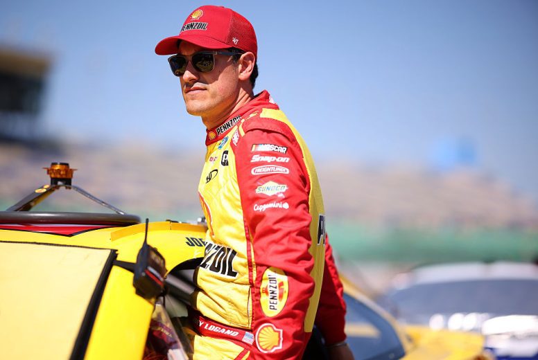 Joey Logano enters his car at Kansas.